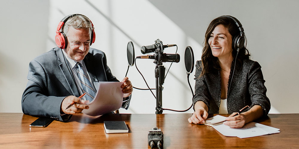 two people talking over microphones